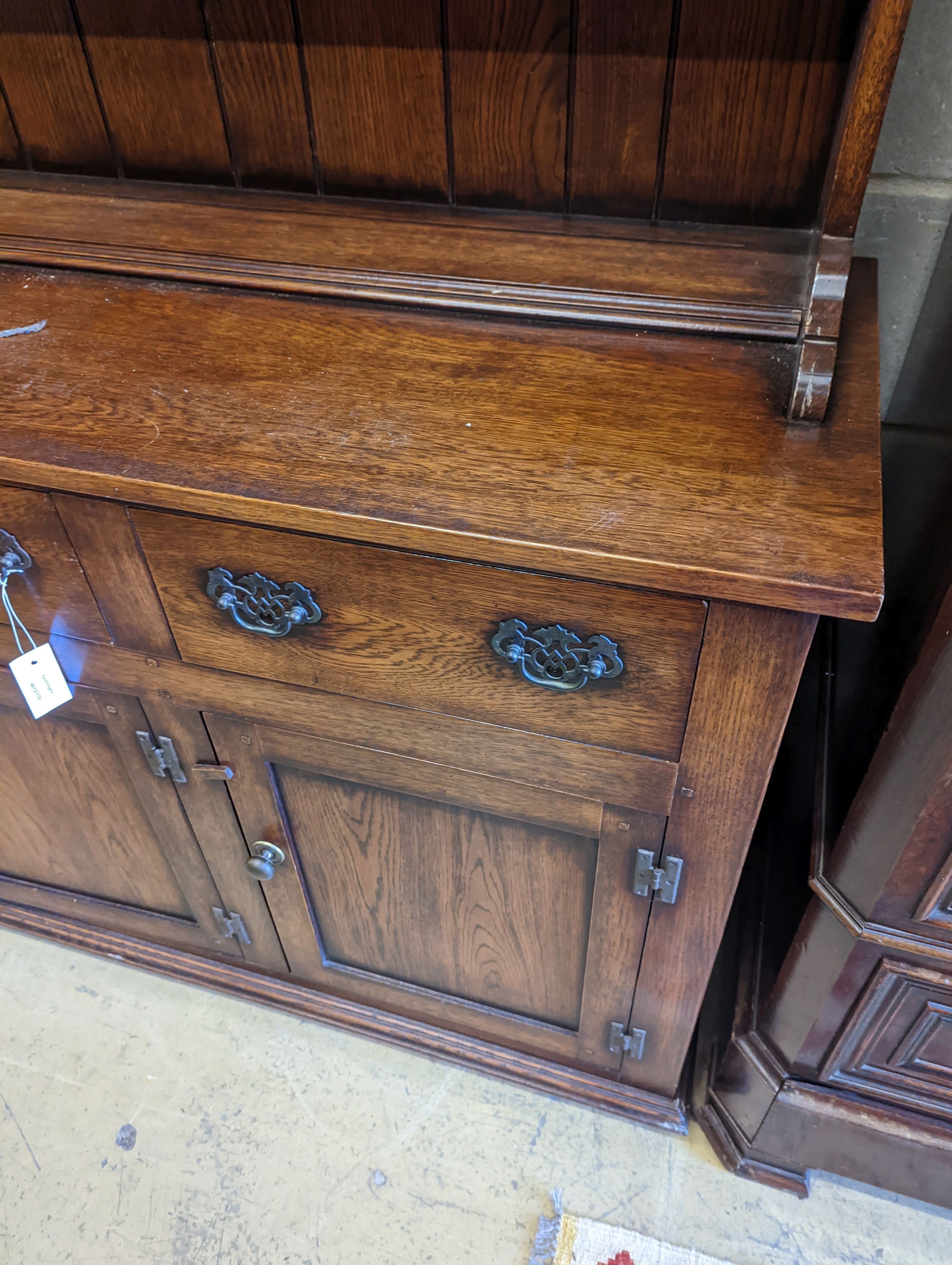 An 18th century style oak dresser with boarded plate rack, width 199cm, depth 48cm, height 198cm